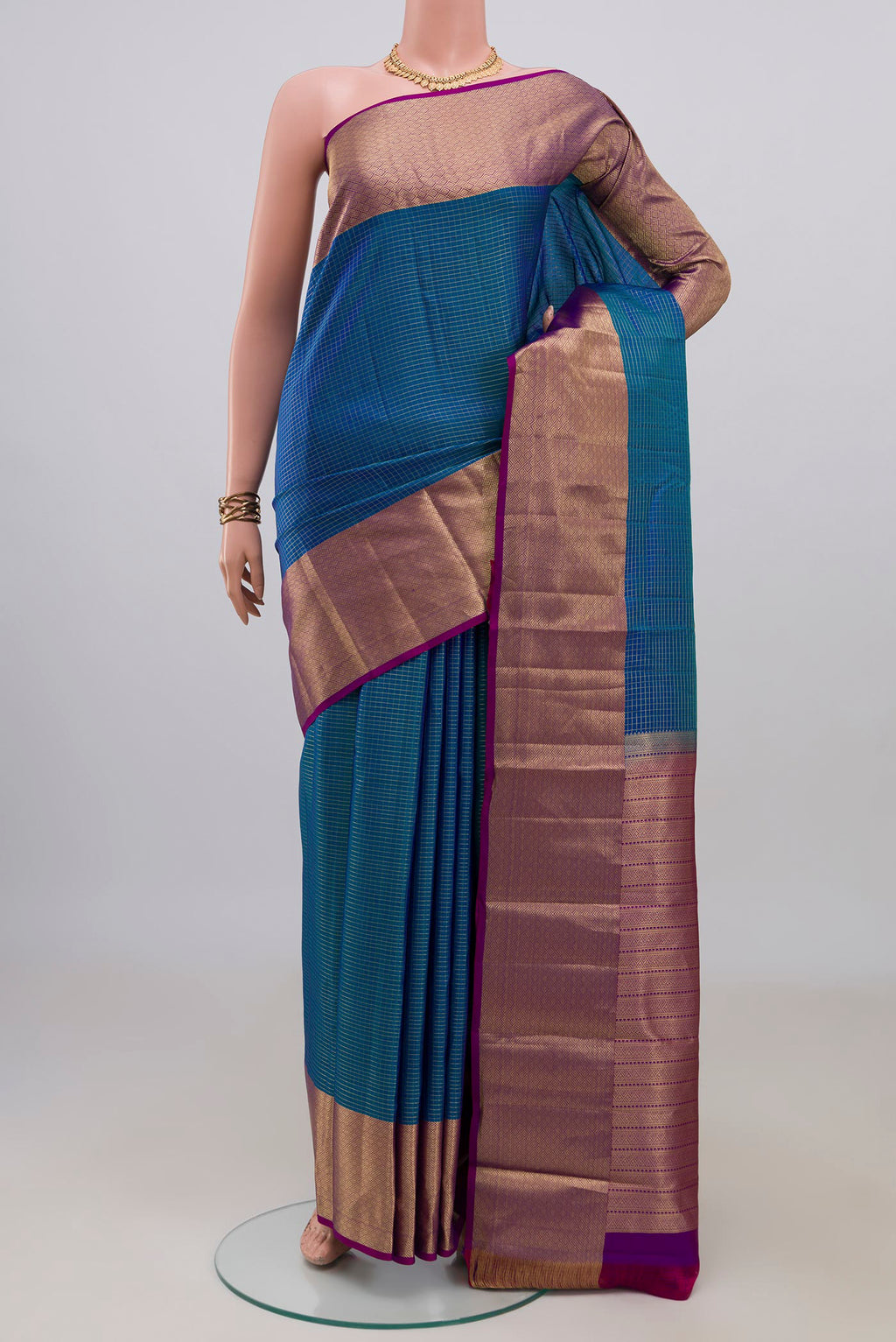 Pure Silk Blue Kanjivaram Saree with Checked design on the body and Zari Border.  displayed on a mannequin
