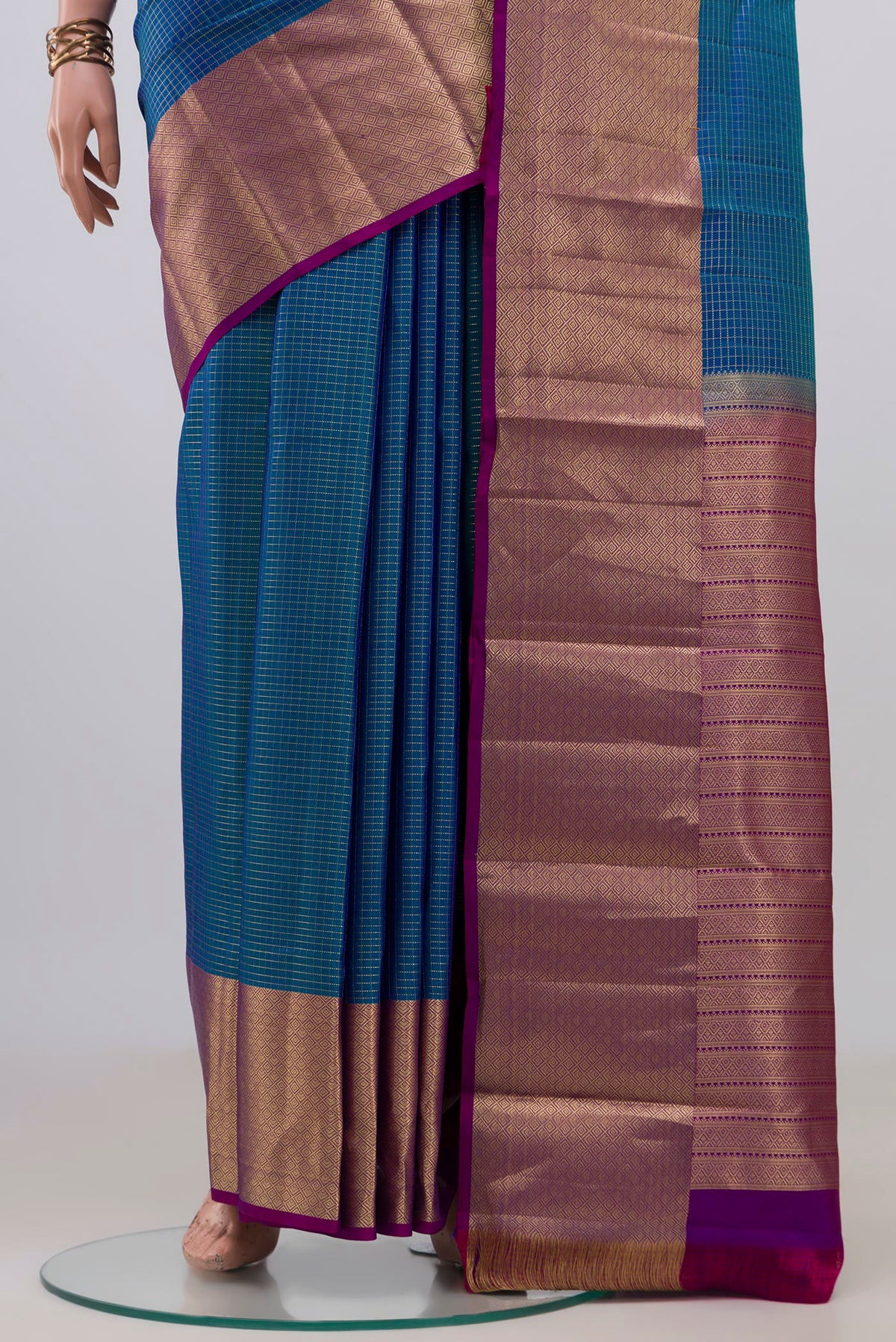 Pleats and pallu of Pure Silk Blue Kanjivaram Saree with Checked design on the body and Zari Border. 