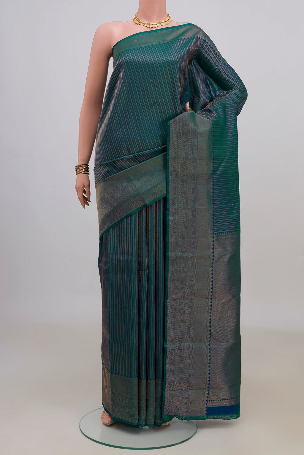 Pure Silk Peacock Blue Dual Tone Kanjivaram Saree with Stripes on the body and Fancy Border.  displayed on a mannequin