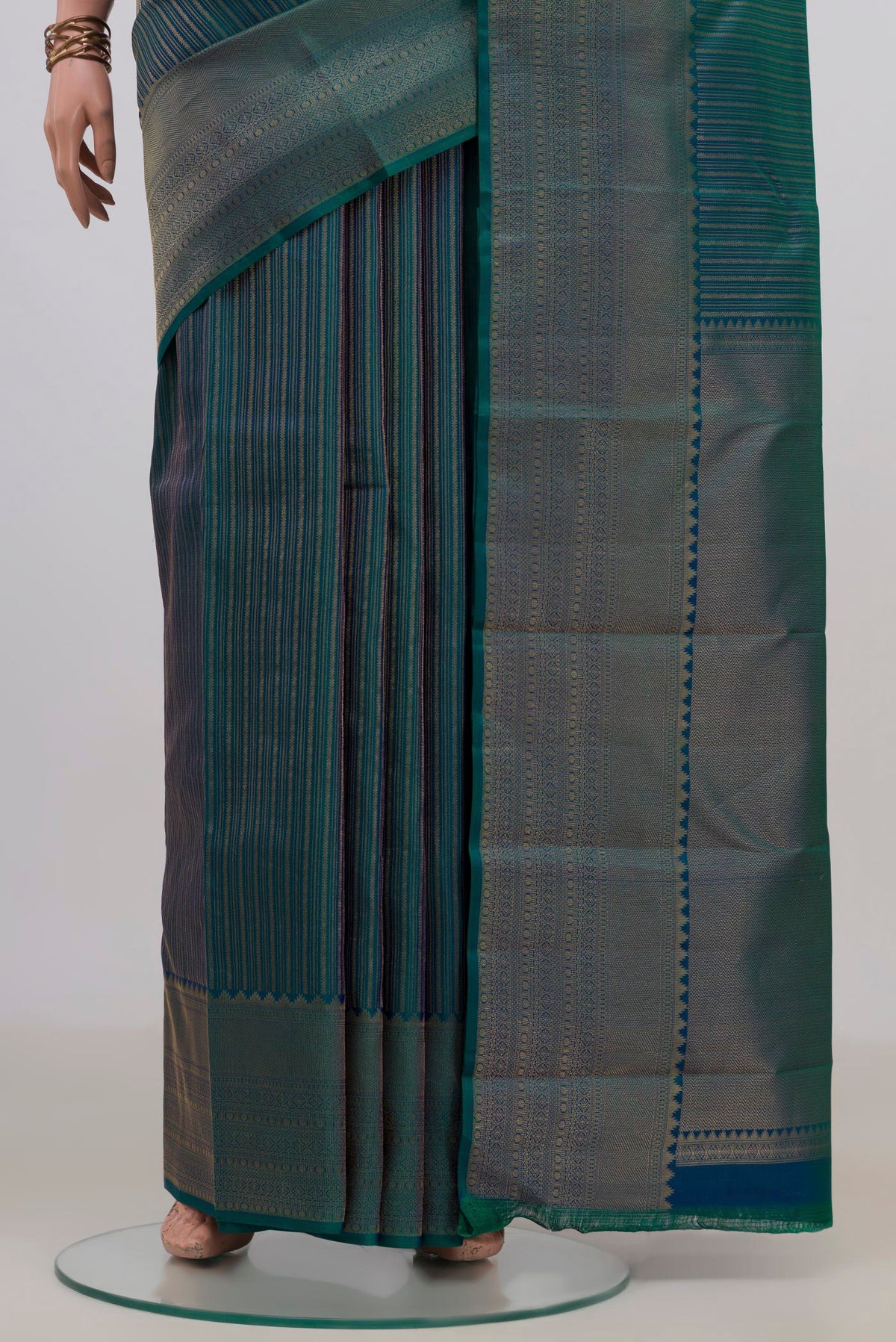 Pleats and pallu of Pure Silk Peacock Blue Dual Tone Kanjivaram Saree with Stripes on the body and Fancy Border. 