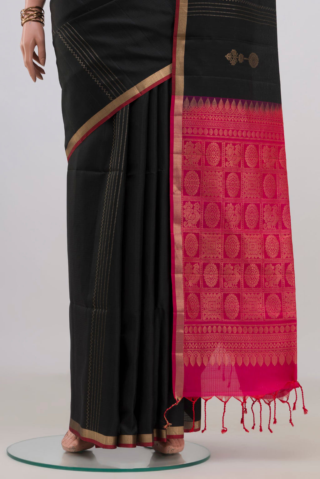 Pleats and pallu of Pure Silk Black Soft Saree with Zari Butta on the body and Thin Zari Line. 