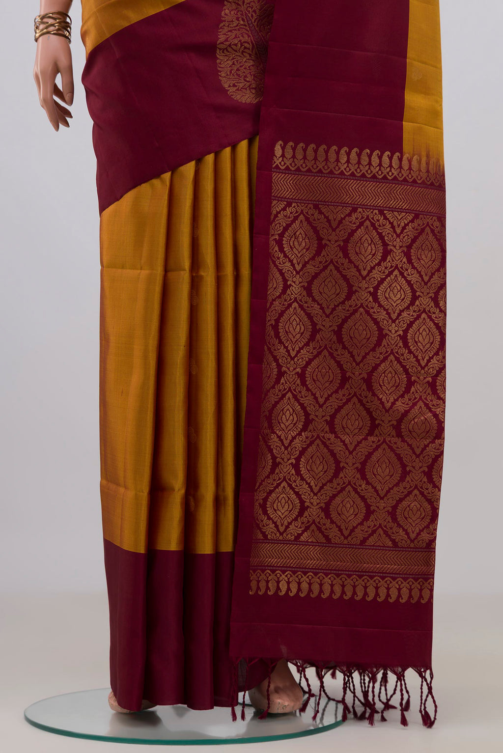 Pleats and pallu of Pure Silk Mustard Soft Saree with Zari Butta on the body and Plain Border. 