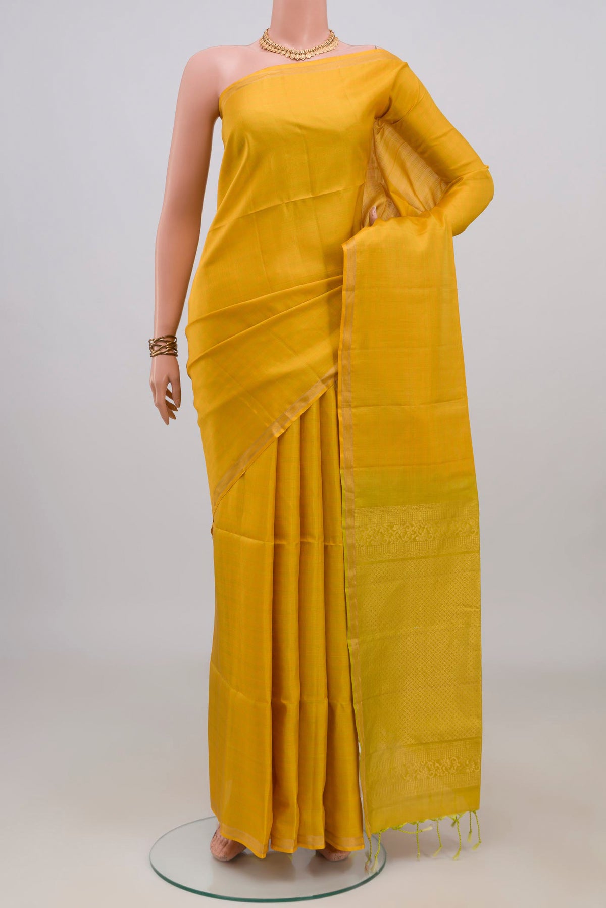 Pure Silk Yellow Soft Saree with Checked design on the body and Thin Zari Line.  displayed on a mannequin