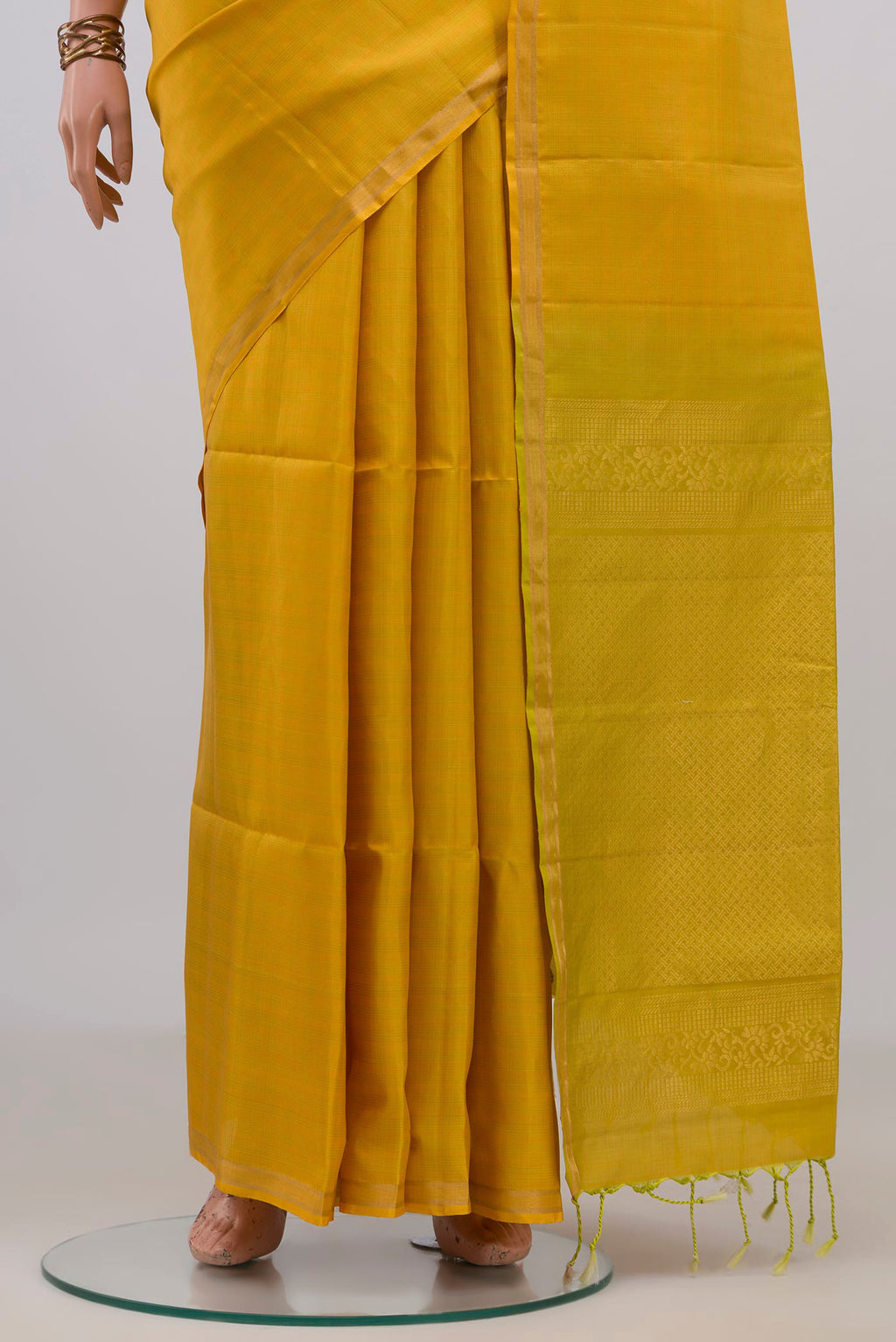 Pleats and pallu of Pure Silk Yellow Soft Saree with Checked design on the body and Thin Zari Line. 