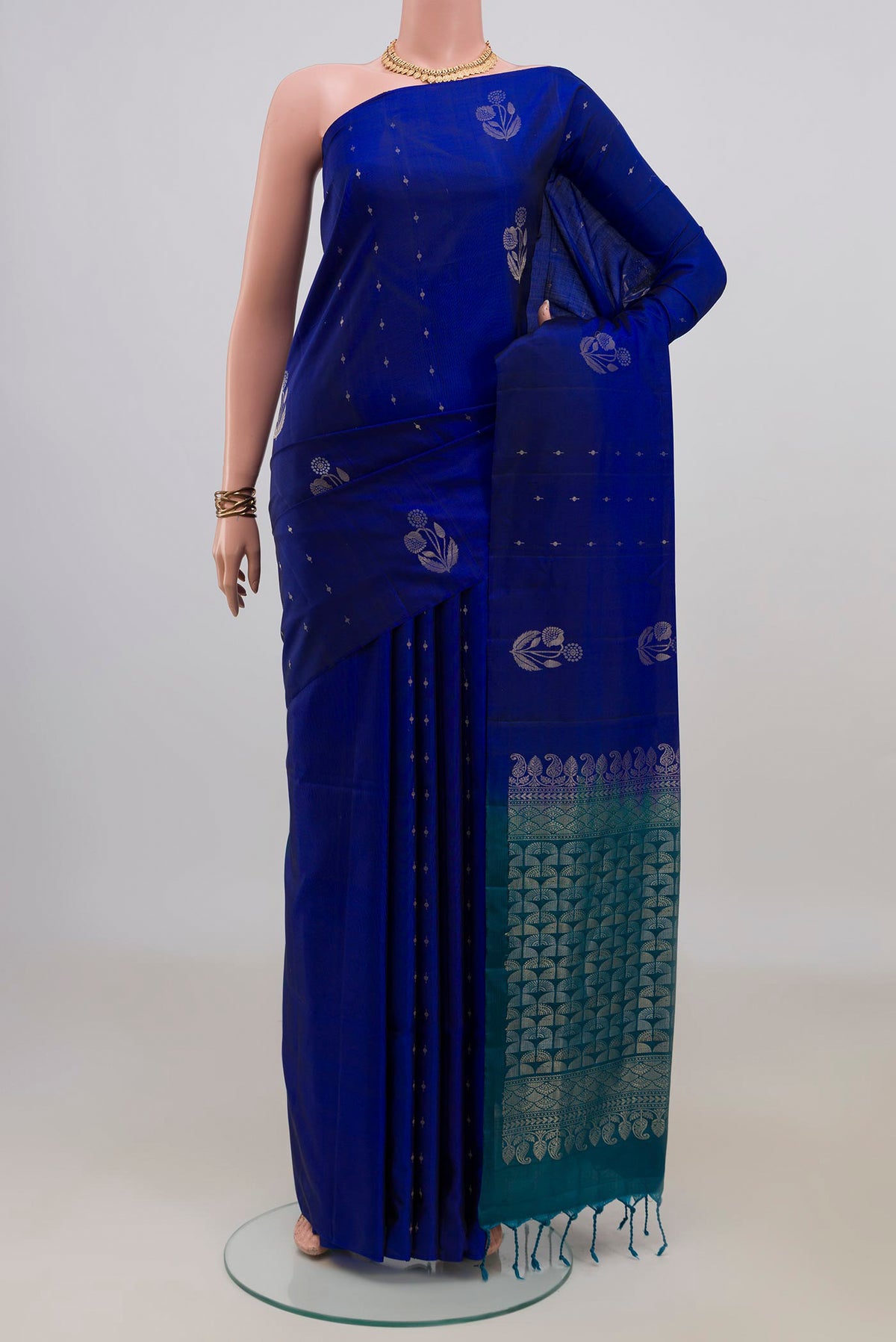 Pure Silk Royal Blue Soft Saree with Zari Butta on the body and Without Border.  displayed on a mannequin