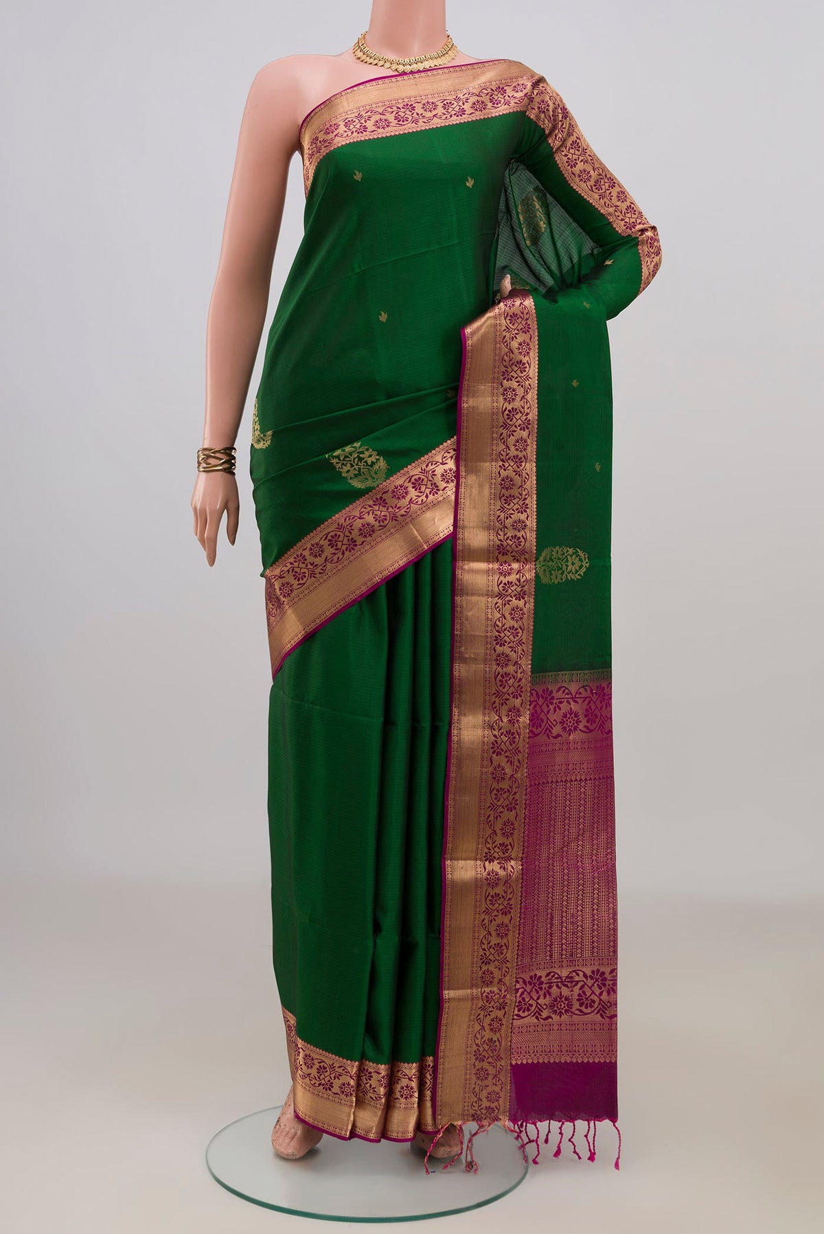 Pure Silk Green Soft Saree with Zari Butta on the body and Zari Border.  displayed on a mannequin