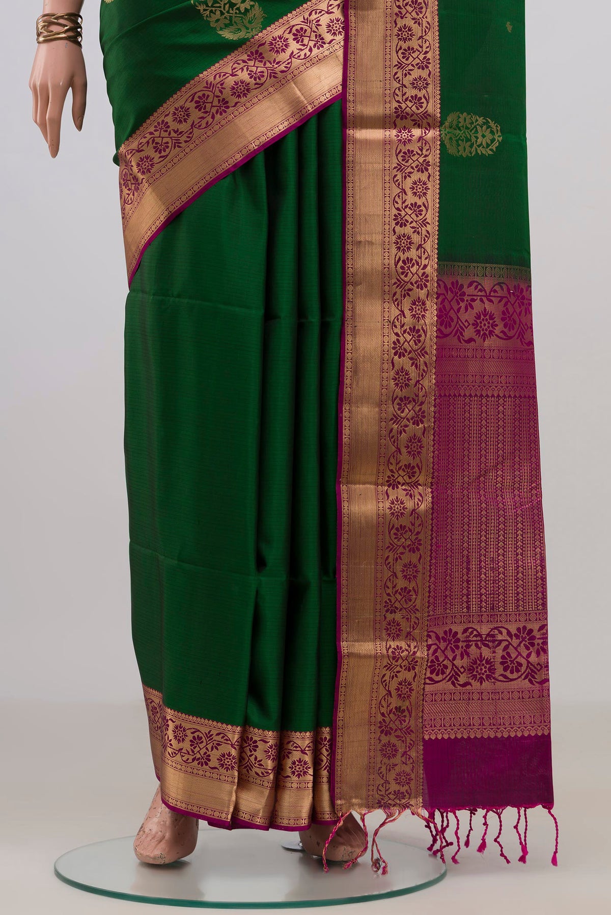 Pleats and pallu of Pure Silk Green Soft Saree with Zari Butta on the body and Zari Border. 