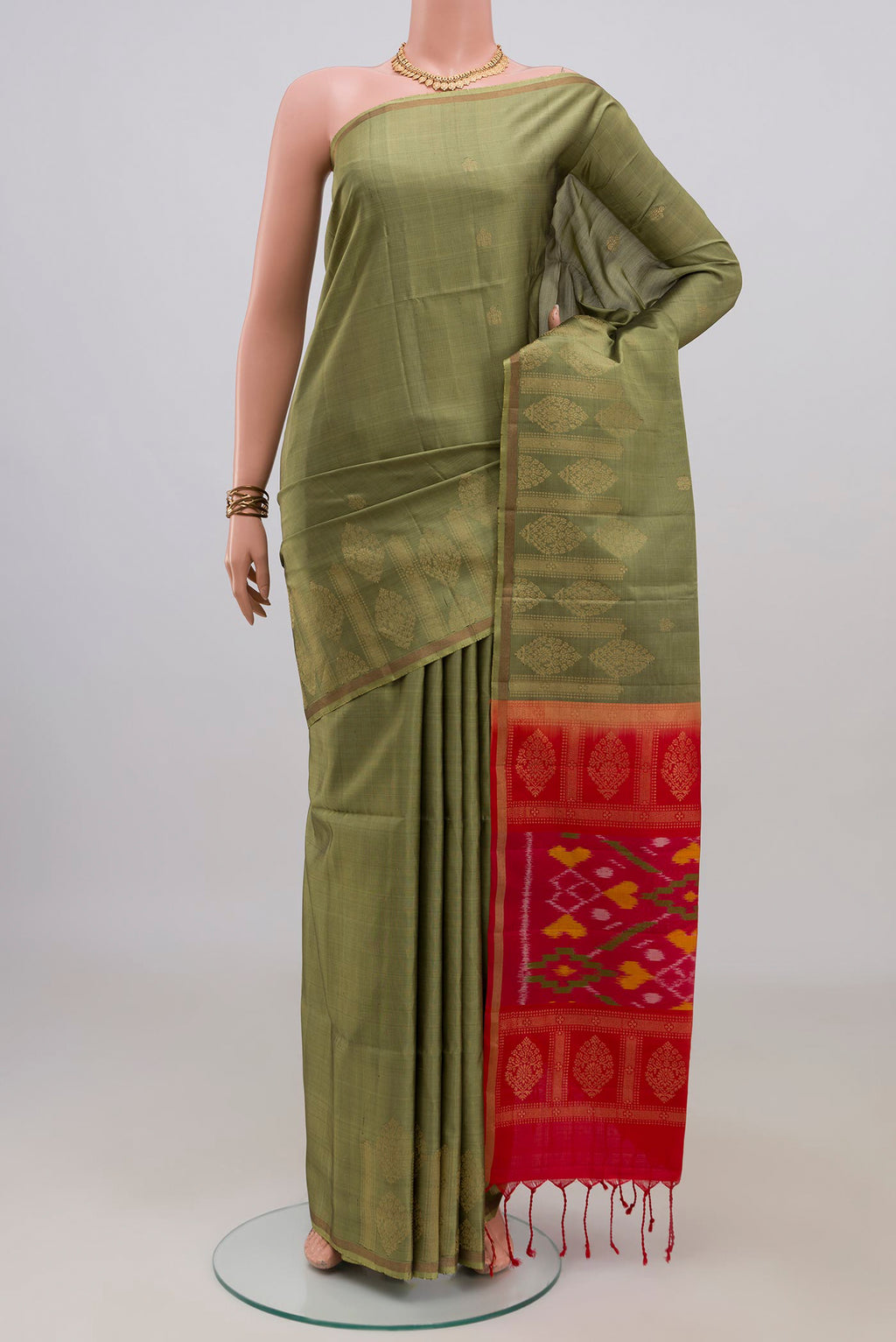 Pure Silk Mehandi Green Soft Saree with Zari Butta on the body and Thin Zari Line.  displayed on a mannequin