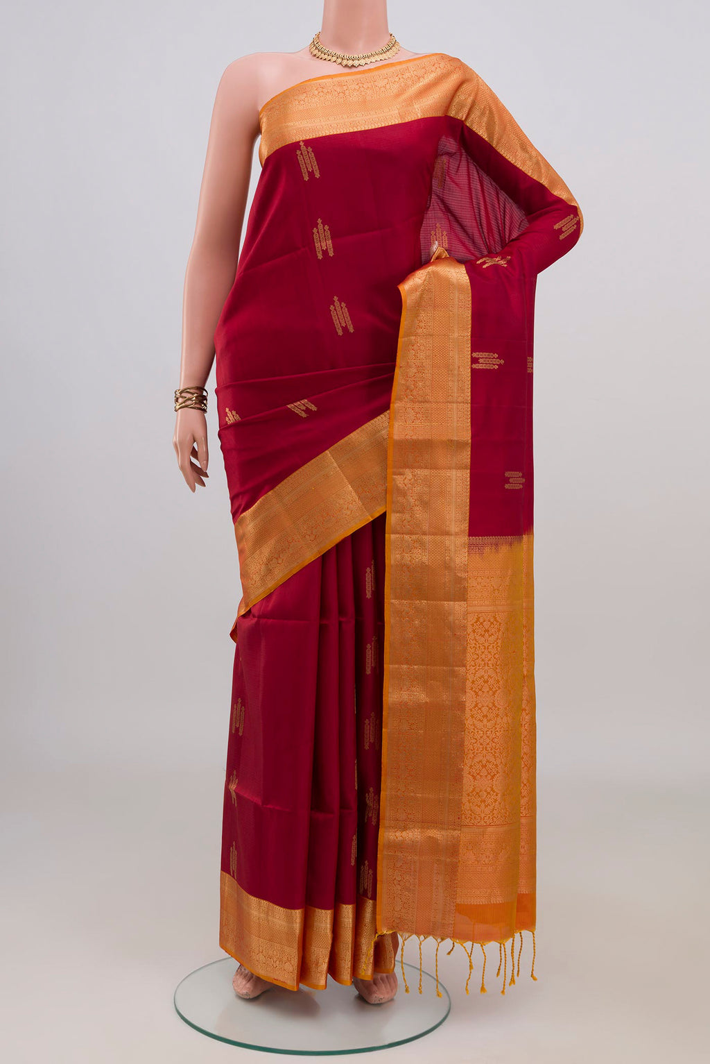 Pure Silk Maroon Soft Saree with Zari Butta on the body and Zari Border.  displayed on a mannequin