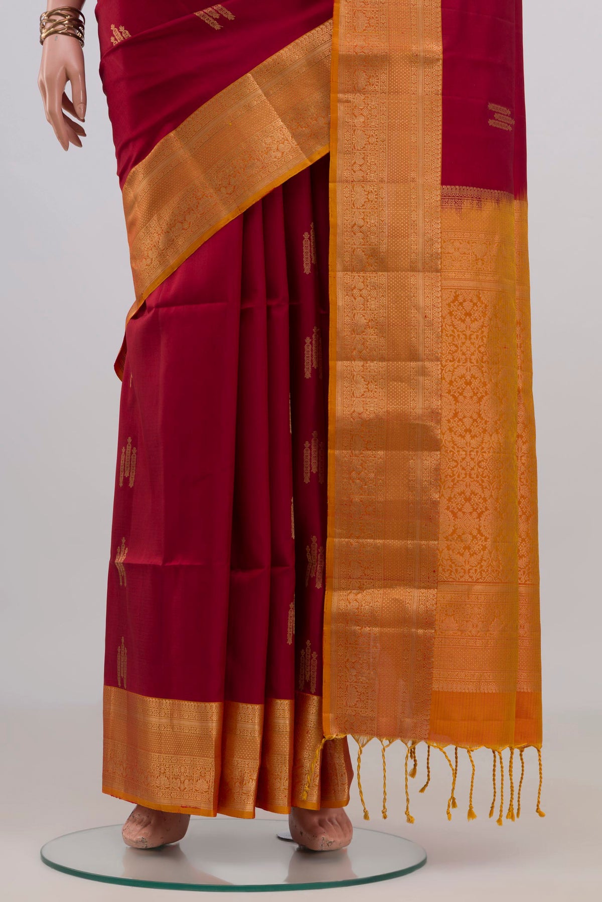 Pleats and pallu of Pure Silk Maroon Soft Saree with Zari Butta on the body and Zari Border. 