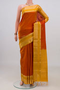 Pure Silk Brick Orange Soft Saree with Zari Butta on the body and Zari Border.  displayed on a mannequin