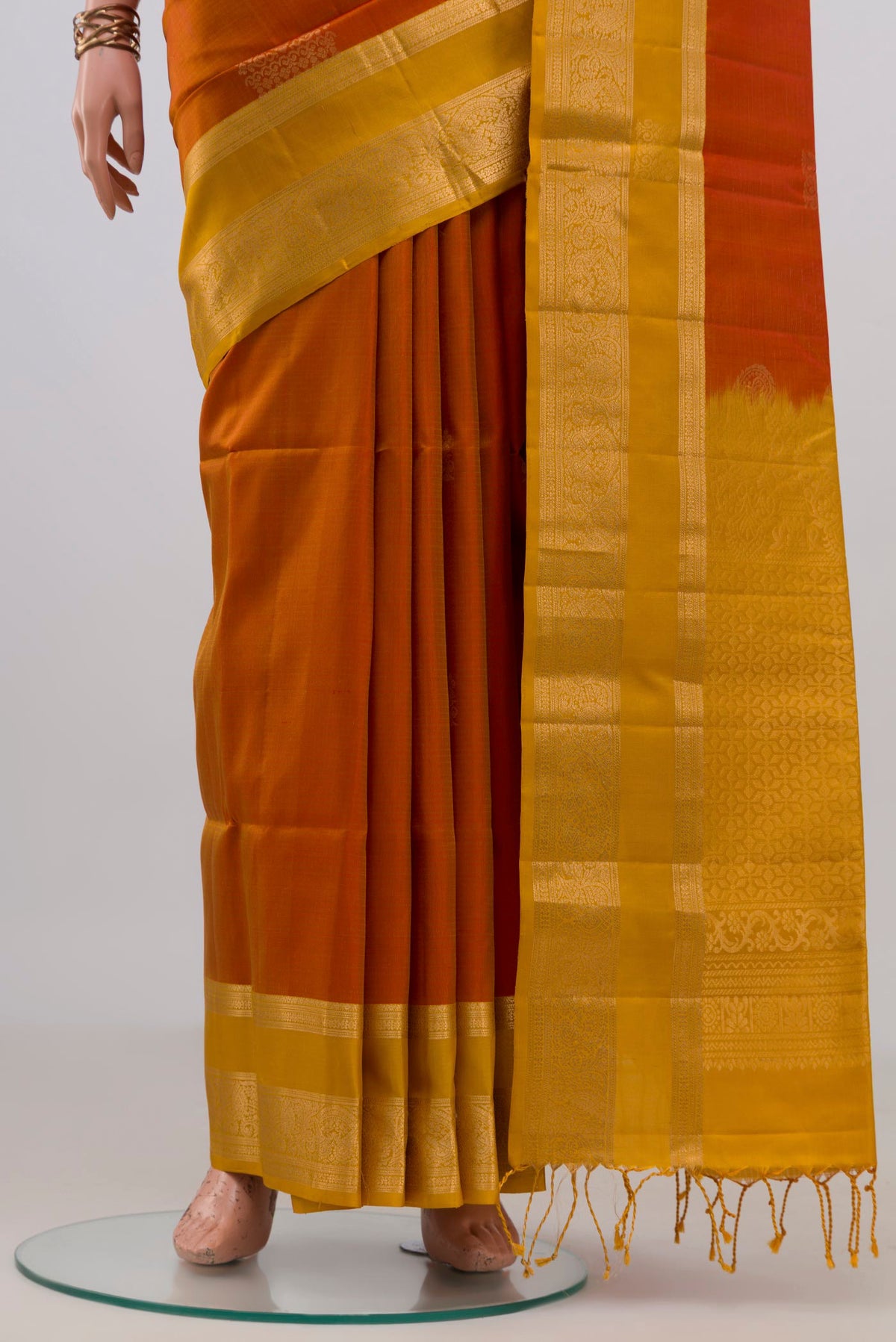 Pleats and pallu of Pure Silk Brick Orange Soft Saree with Zari Butta on the body and Zari Border. 