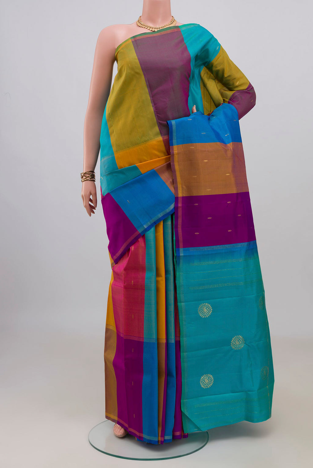 Pure Silk Multi Color Kanchipuram Saree with Stripes on the body and Thin Zari Line.  displayed on a mannequin