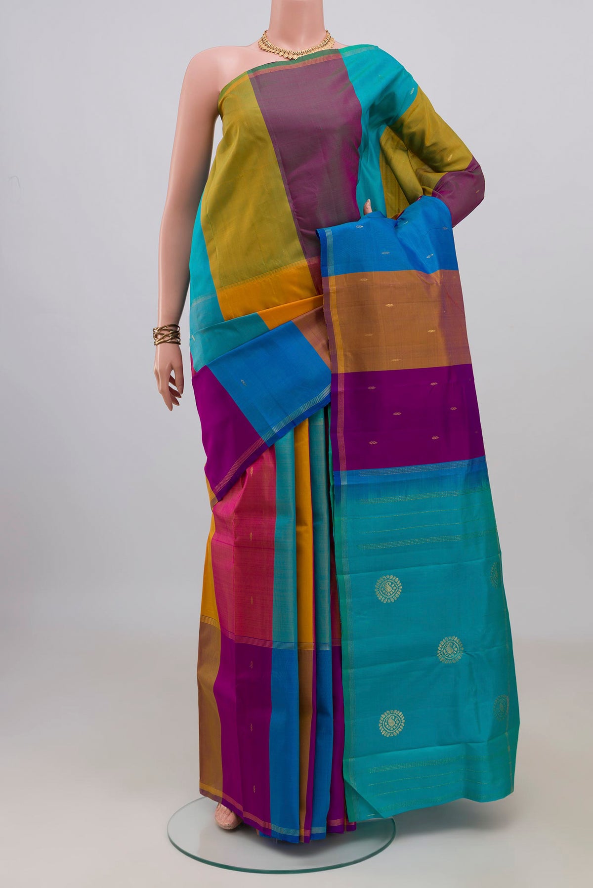 Pure Silk Multi Color Kanchipuram Saree with Stripes on the body and Thin Zari Line.  displayed on a mannequin