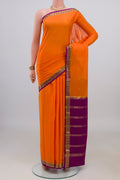 Orange Mysore Crepe Saree with Zari Butta on the body and Zari Border.  displayed on a mannequin