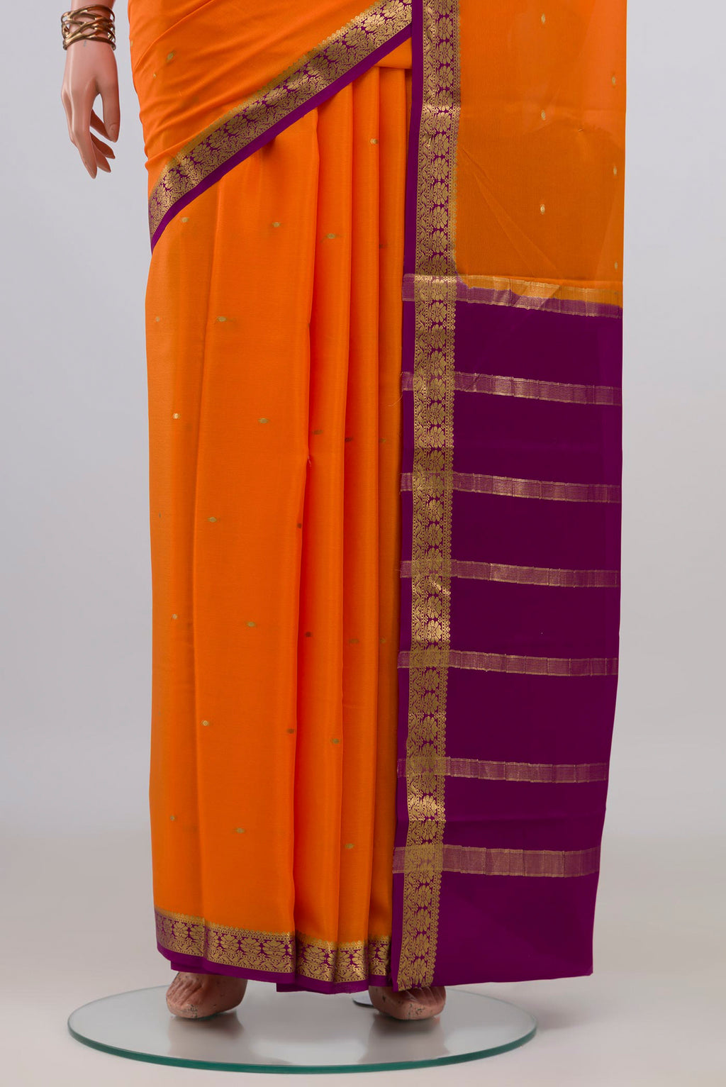 Pleats and pallu of Orange Mysore Crepe Saree with Zari Butta on the body and Zari Border. 