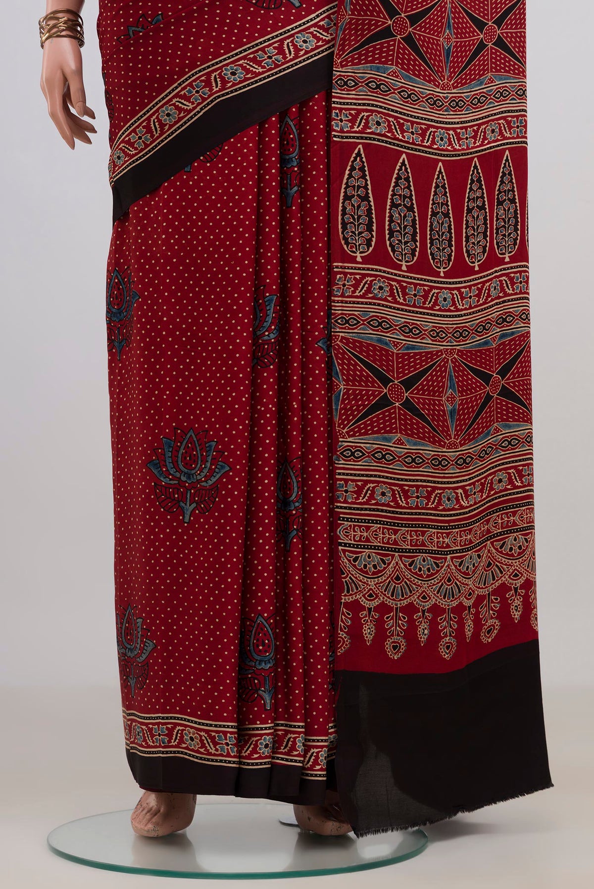 Pleats and pallu of Maroon Blended Satin Silk Saree with Ajrakh Print on the body and Without Border. 