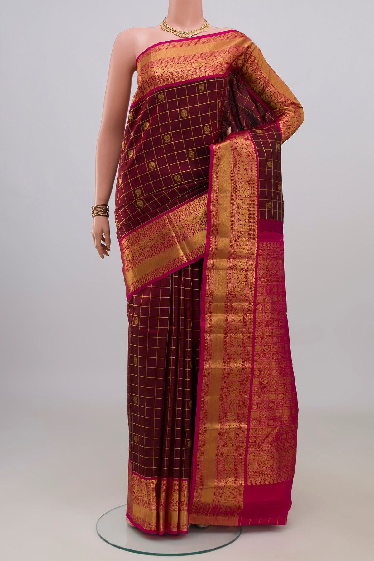 Pure Silk Maroon Kanchipuram Saree with Checked design on the body and Zari Border.  displayed on a mannequin