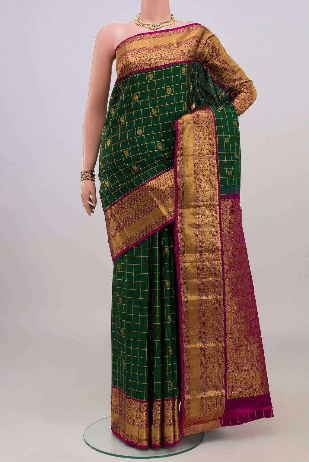 Pure Silk Bottle Green Kanchipuram Saree with Checked design on the body and Zari Border.  displayed on a mannequin