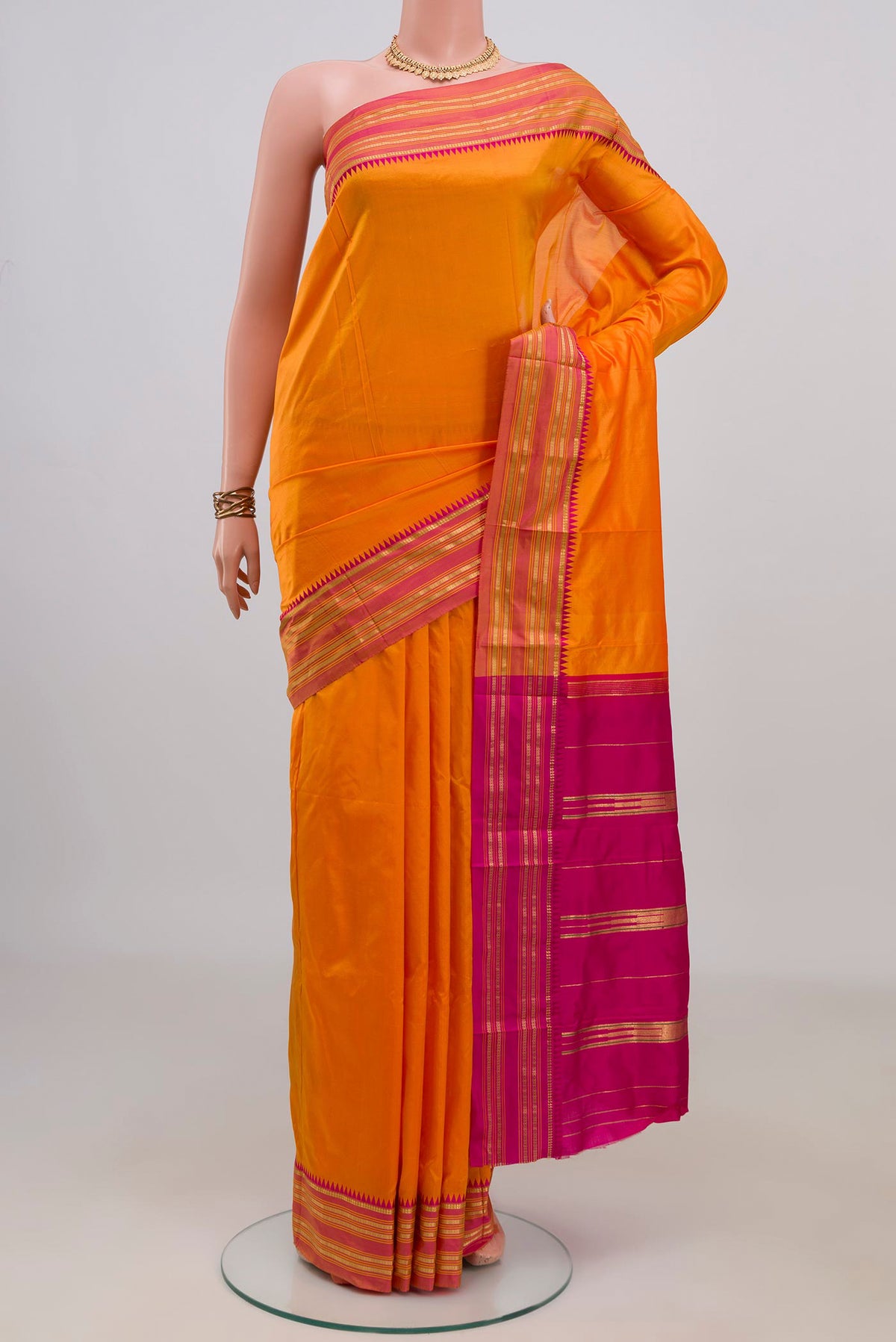 Pure Silk Orange Narayanpet Saree with Plain Body and Zari Border.  displayed on a mannequin