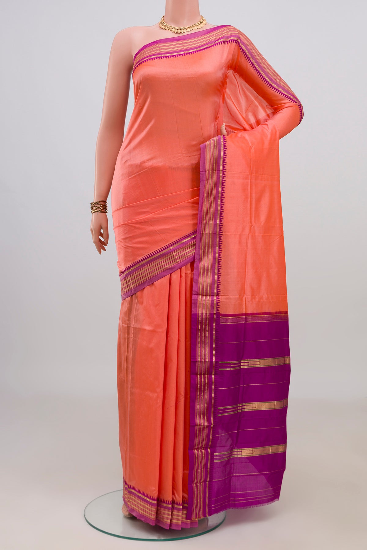 Pure Silk Peach Narayanpet Saree with Plain Body and Zari Border.  displayed on a mannequin