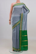 Pure Silk Grey Narayanpet Saree with Plain Body and Zari Border.  displayed on a mannequin