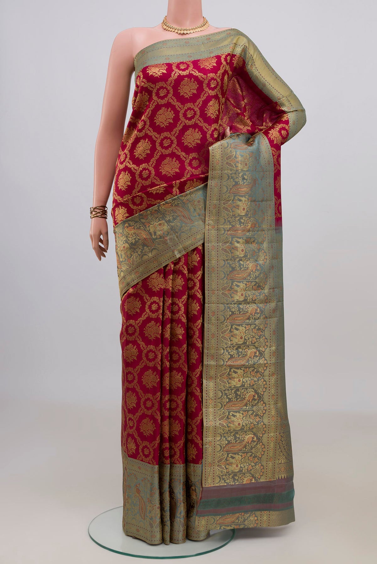 Pure Silk Maroon Kanchipuram Saree with Zari Brocade on the body and Fancy Border.  displayed on a mannequin