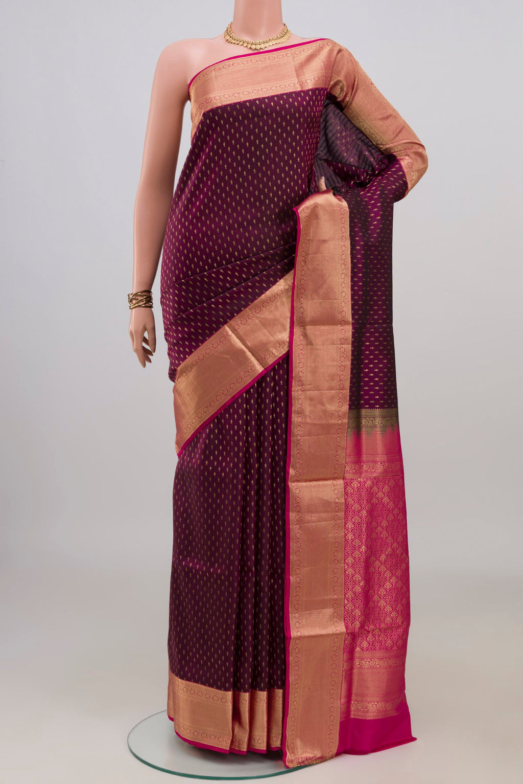 Pure Silk Magenta Soft Saree with Zari Butta on the body and Zari Border.  displayed on a mannequin
