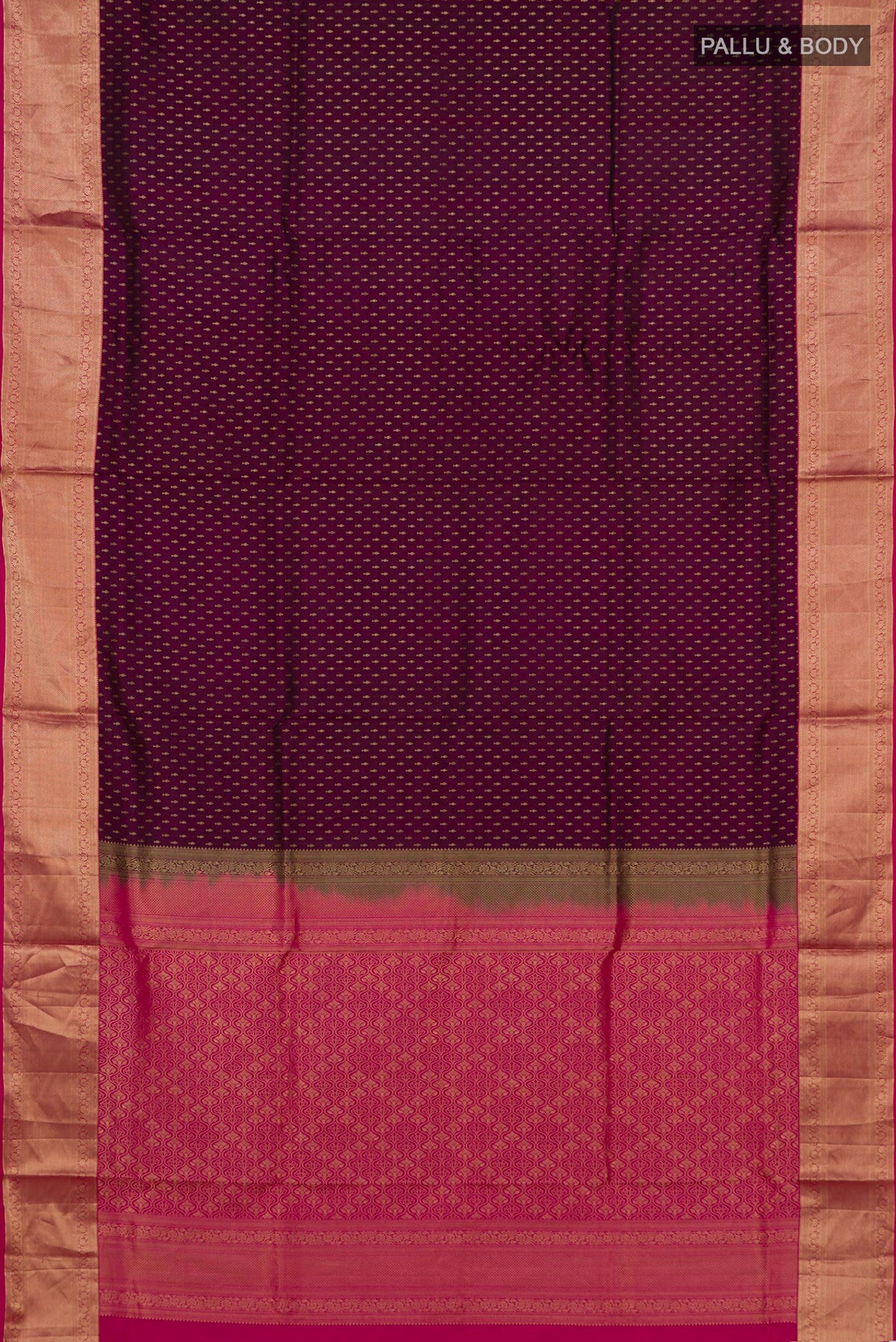 Flat view of Pure Silk Magenta Soft Saree with Zari Butta on the body and Zari Border. 