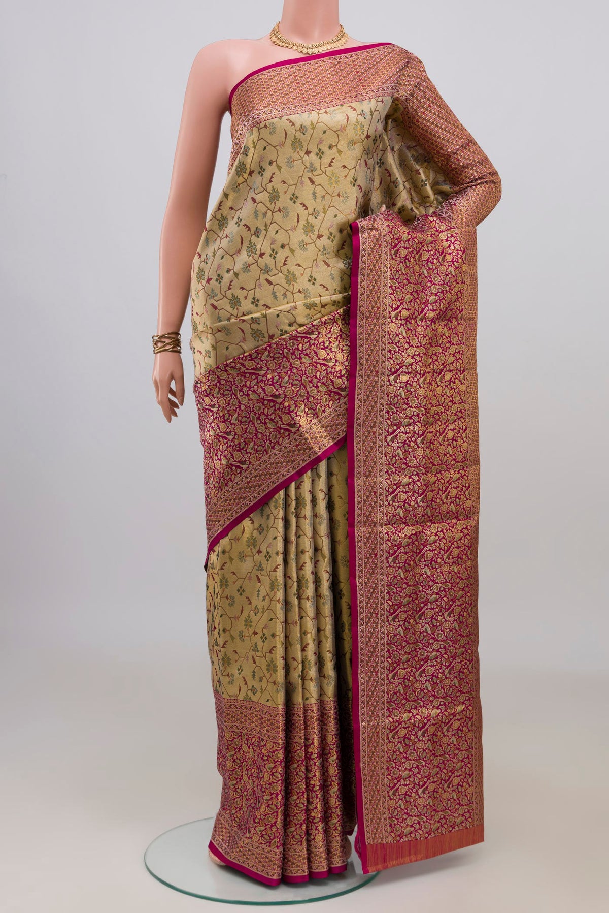 Golden Dual Tone Kanchipuram Tissue Saree with Zari Brocade on the body and Fancy Border.  displayed on a mannequin