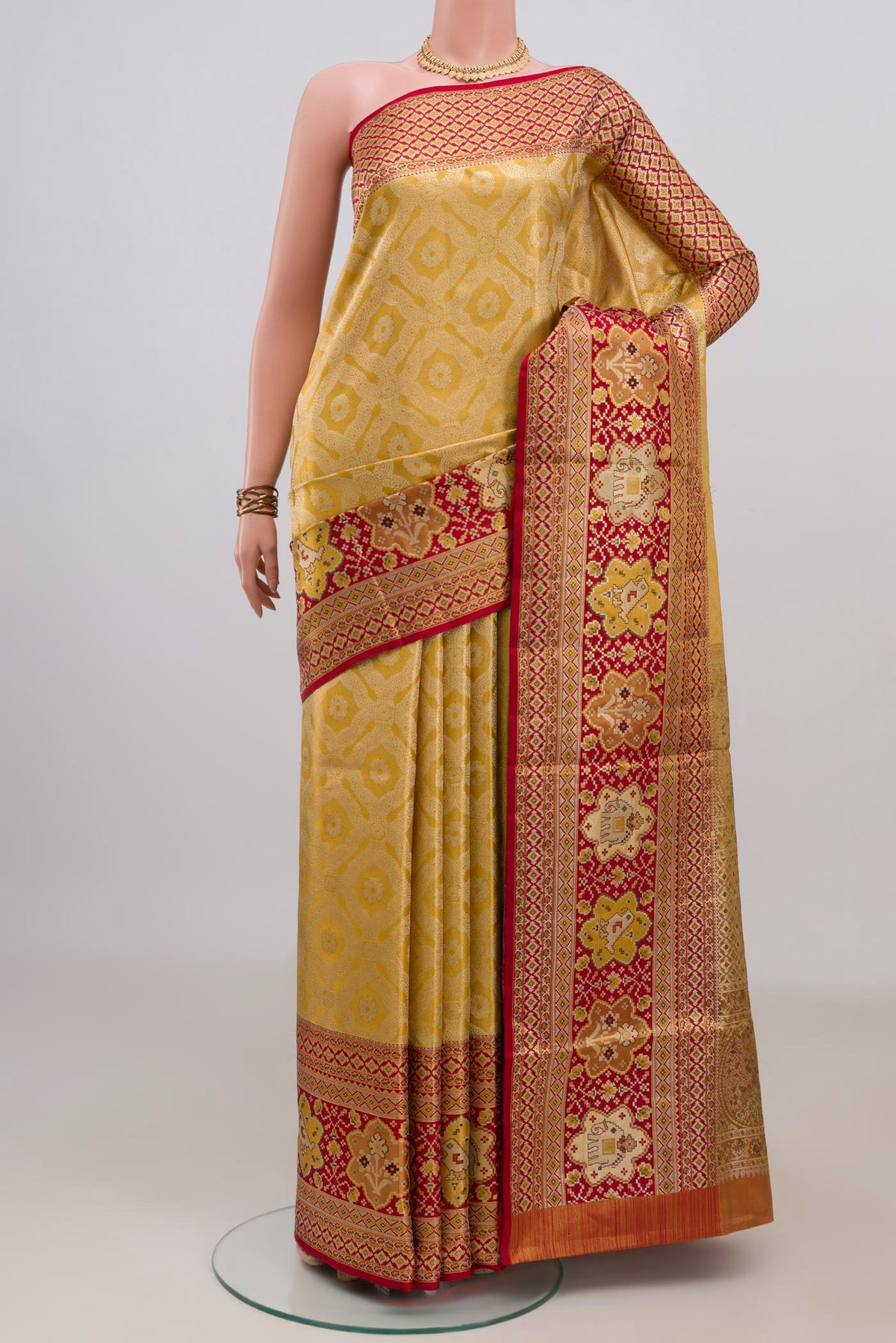 Golden Dual Tone Kanchipuram Tissue Saree with Zari Brocade on the body and Fancy Border.  displayed on a mannequin
