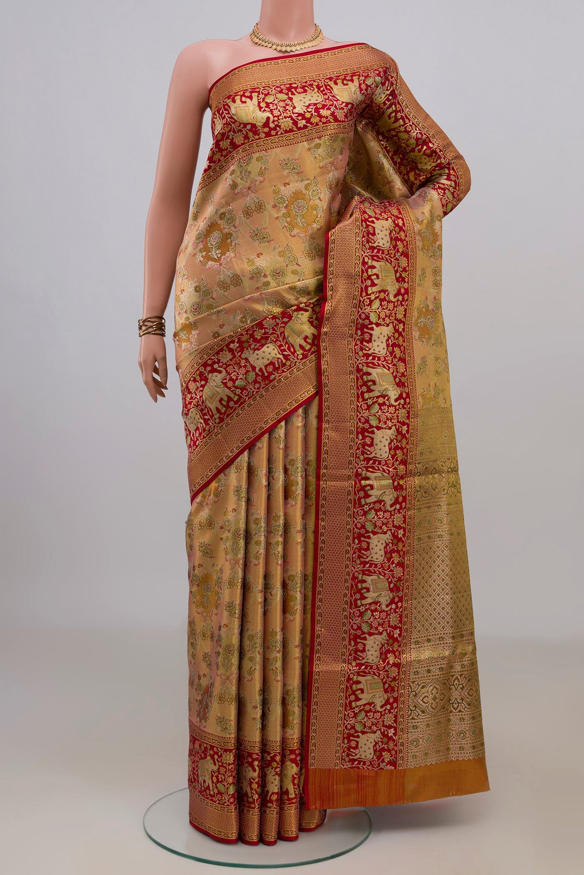Peach Dual Tone Kanchipuram Saree with Zari Brocade on the body and Fancy Border.  displayed on a mannequin