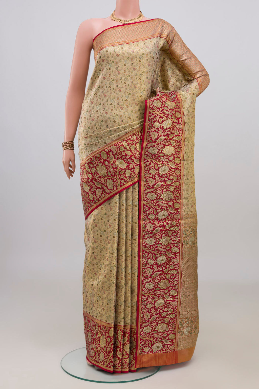 Gold Kanchipuram Tissue Saree with Zari Brocade on the body and Zari Border.  displayed on a mannequin