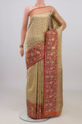 Gold Kanchipuram Tissue Saree with Zari Brocade on the body and Zari Border.  displayed on a mannequin