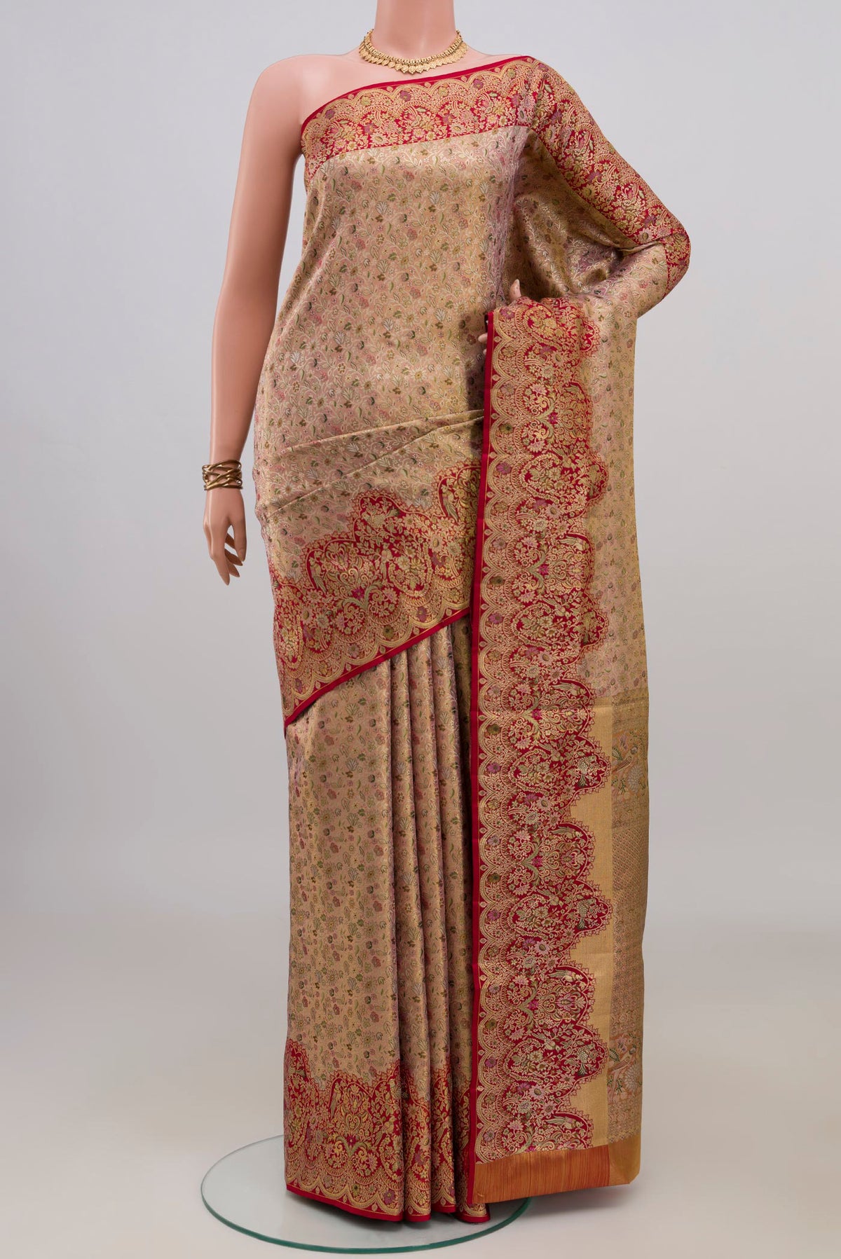 Golden Peach Kanchipuram Tissue Saree with Zari Brocade on the body and Fancy Border.  displayed on a mannequin