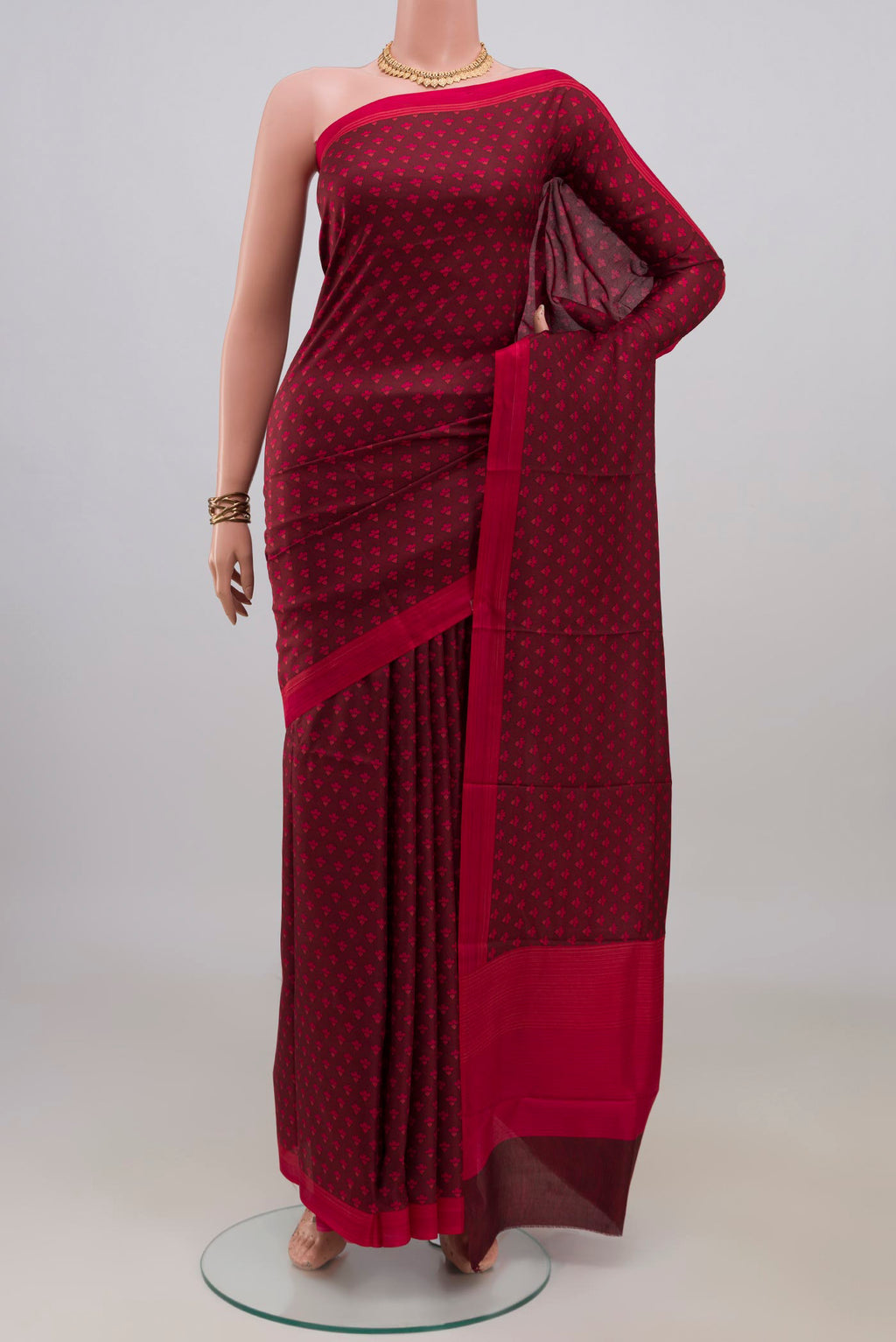 Pure Silk Maroon Printed Saree with Printed design on the body and Plain Border.  displayed on a mannequin