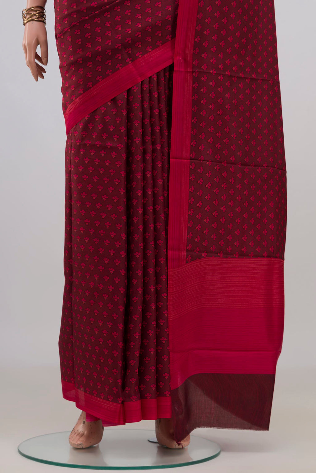 Pleats and pallu of Pure Silk Maroon Printed Saree with Printed design on the body and Plain Border. 