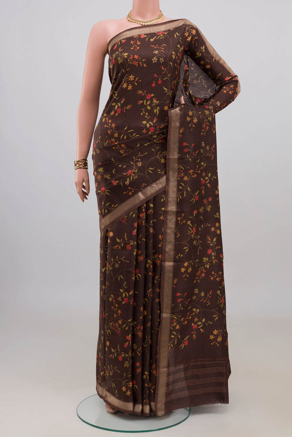 Pure Silk Brown Printed Saree with Printed design on the body and Zari Border.  displayed on a mannequin