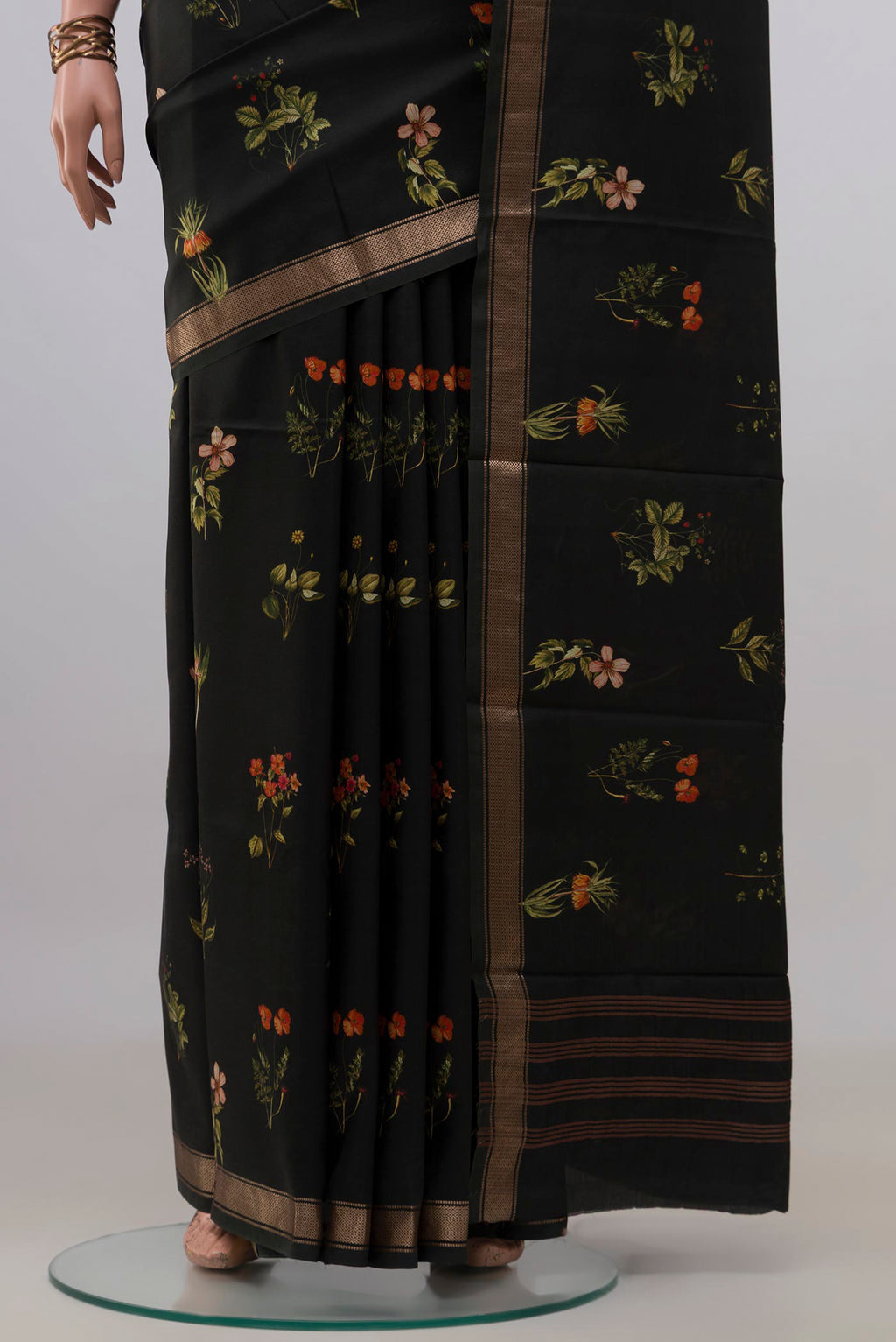 Pleats and pallu of Pure Silk Black Printed Saree with Printed design on the body and Zari Border. 