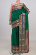 Pure Silk Green Kanjivaram Saree with Zari Butta on the body and Zari Border.  displayed on a mannequin