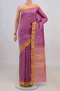 Pure Silk Pink Kanchipuram Saree with Zari Butta on the body and Zari Border.  displayed on a mannequin
