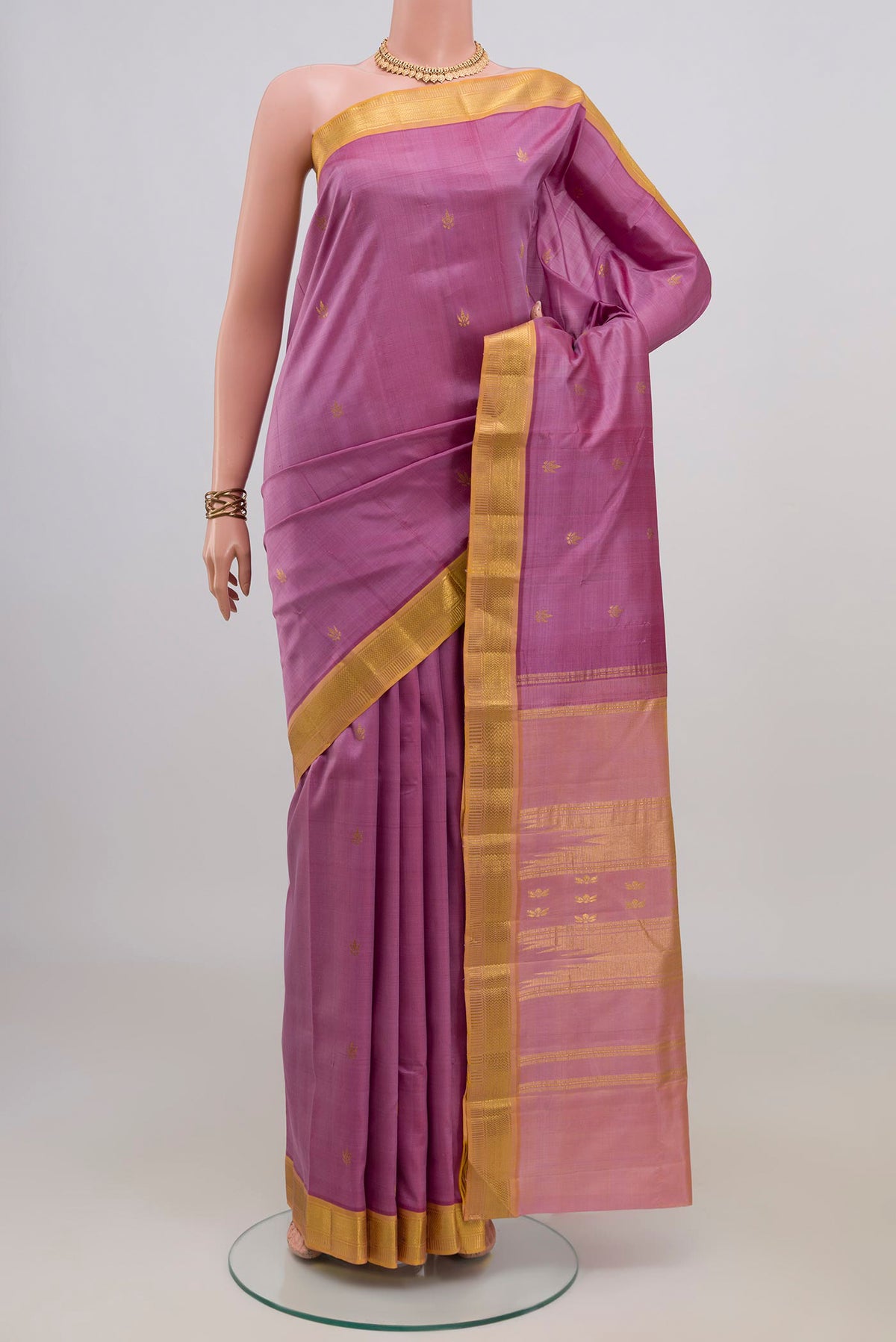 Pure Silk Pink Kanchipuram Saree with Zari Butta on the body and Zari Border.  displayed on a mannequin