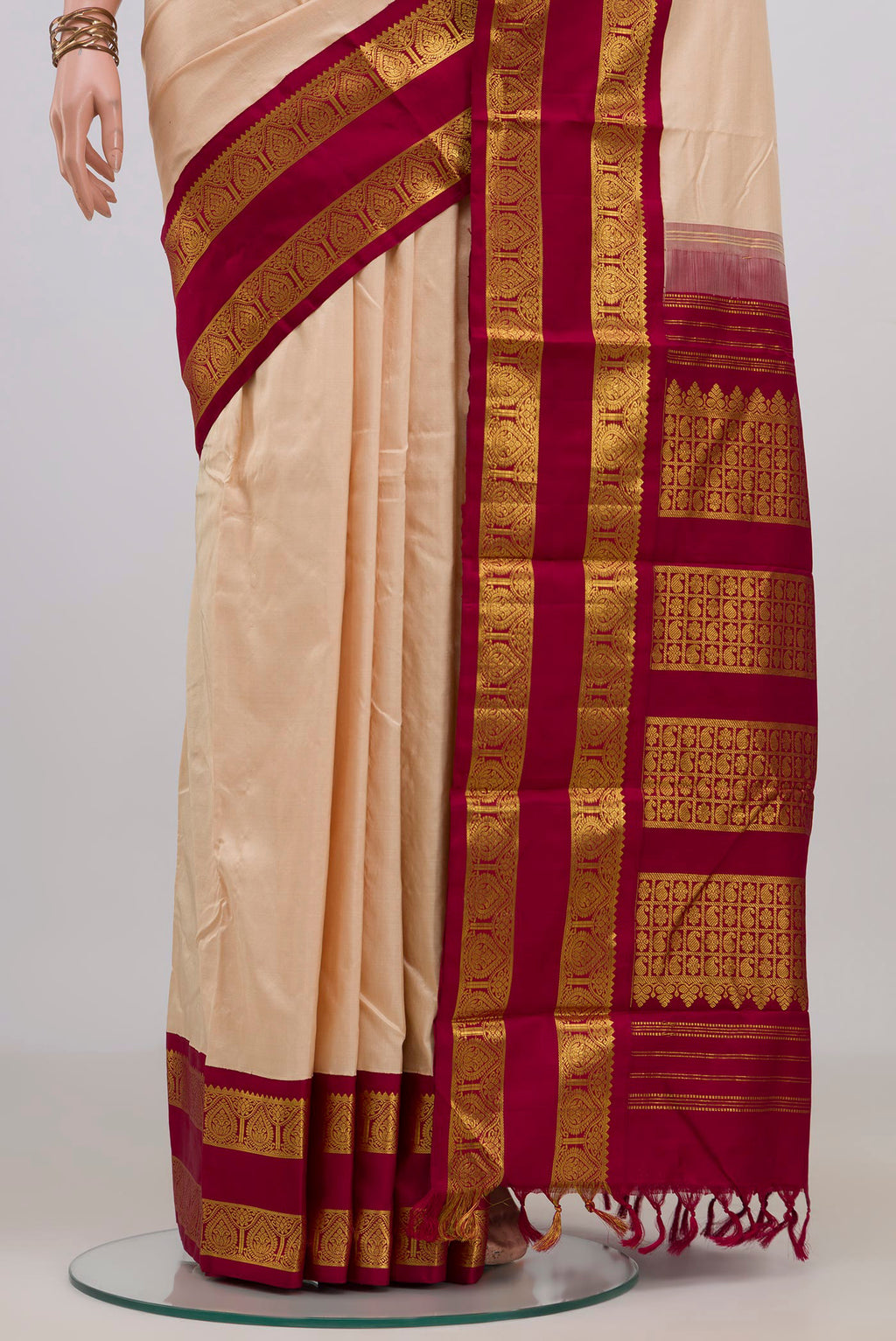 Pleats and pallu of Pure Silk Cream Kanjivaram Saree with Plain Body and Zari Border. 
