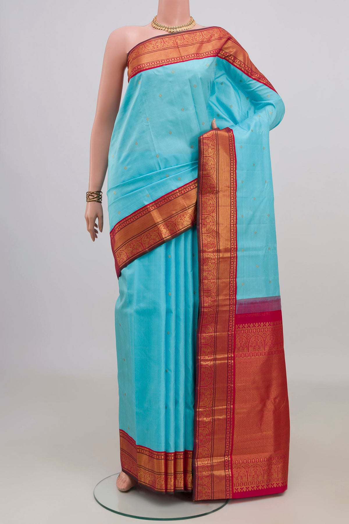 Pure Silk Light Blue Kanjivaram Saree with Zari Butta on the body and Zari Border.  displayed on a mannequin