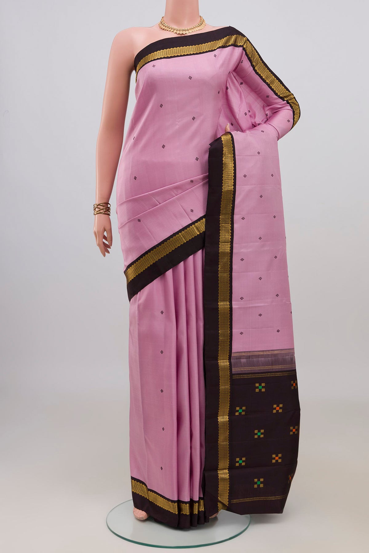 Pure Silk Rose pink Kanjivaram Saree with Thread Butta on the body and Zari Border.  displayed on a mannequin