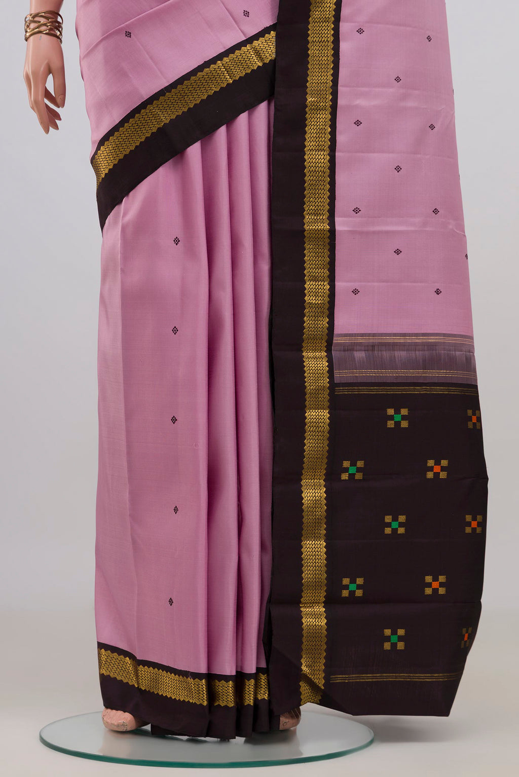 Pleats and pallu of Pure Silk Rose pink Kanjivaram Saree with Thread Butta on the body and Zari Border. 