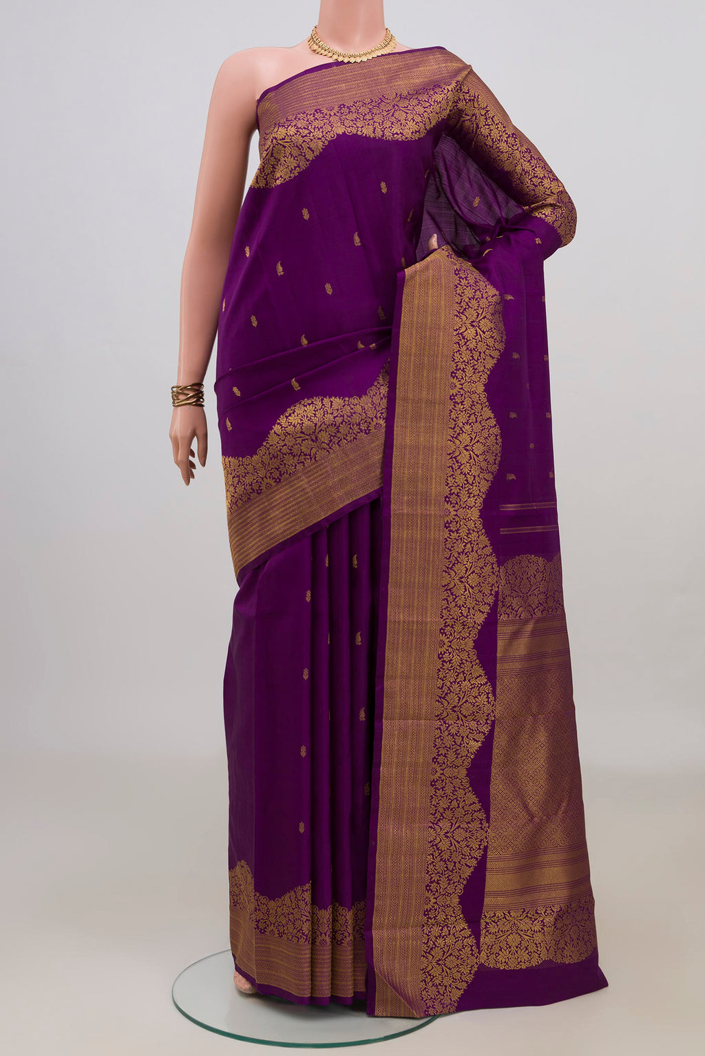 Pure Silk Purple Kanjivaram Saree with Zari Butta on the body and Fancy Border.  displayed on a mannequin