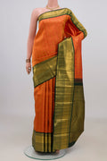 Pure Silk Orange Kanchipuram Saree with Zari Brocade on the body and Zari Border.  displayed on a mannequin