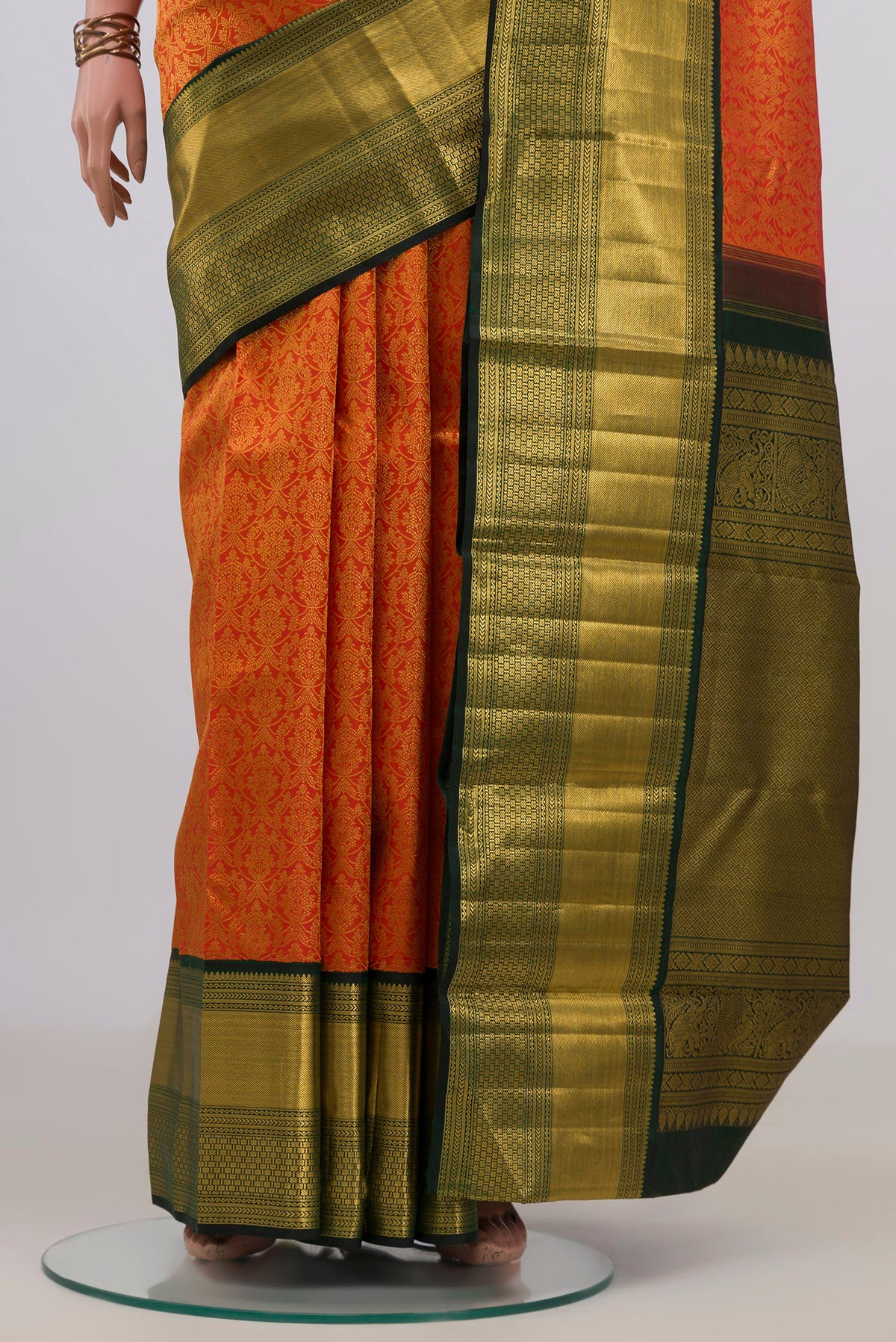 Pleats and pallu of Pure Silk Orange Kanchipuram Saree with Zari Brocade on the body and Zari Border. 