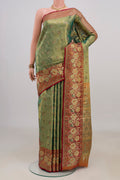 Green Dual Tone Kanjivaram Tissue Saree with Zari Brocade on the body and Fancy Border.  displayed on a mannequin